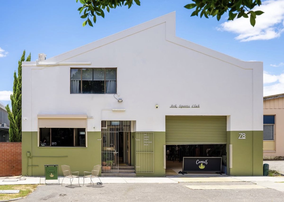 The white and olive-green frontage of Ark Sports Club on Goodwood Parade