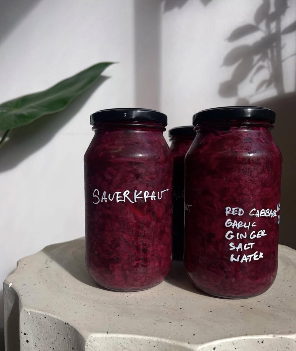 Jars of house-made sauerkraut on a stone bench